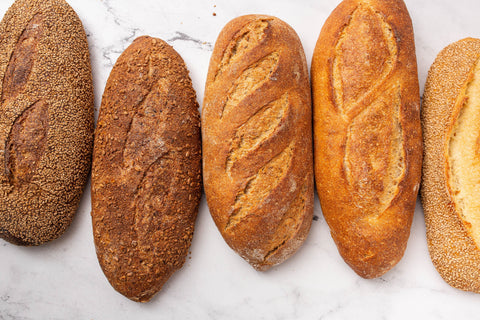 5 loaves of fresh baked bread baked by Berkshire Mountain Bakery with a marble counter background